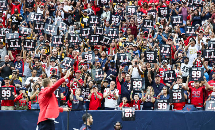 Texans player J.J. Watt waves while fans cheer after Watt is inducted into the Texans Ring of Honor during the game against the Pittsburgh Steelers at NRG Stadium.